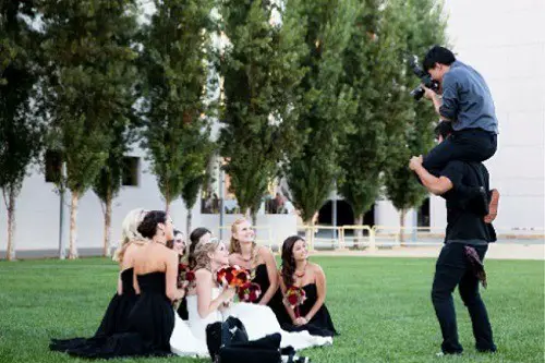 Photographer Taking Photo Of Bride And Bridesmaids